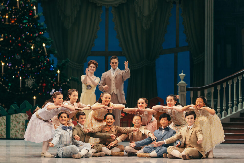 child cast with parents onstage