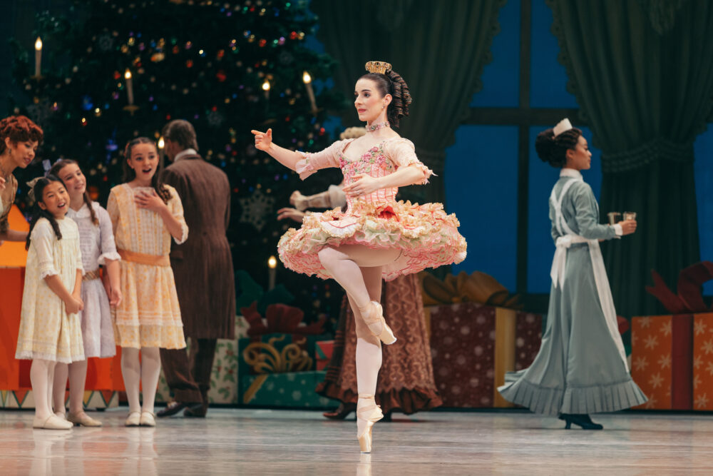 the dancing doll on one foot in a pink tutu