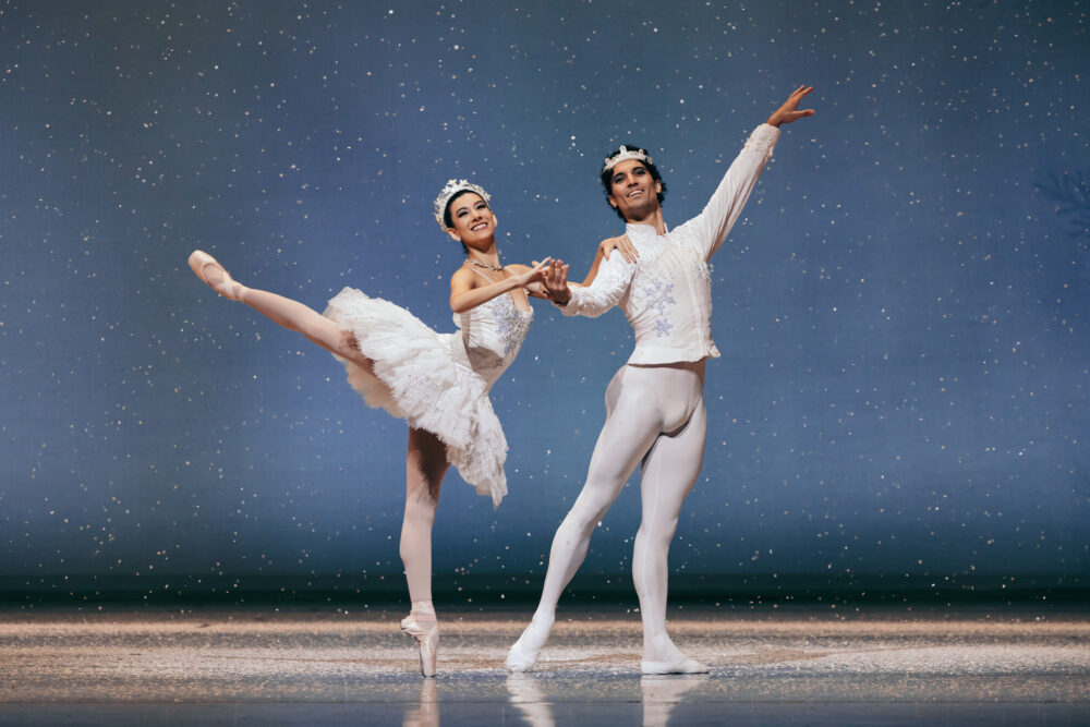 snow queen and king pose onstage