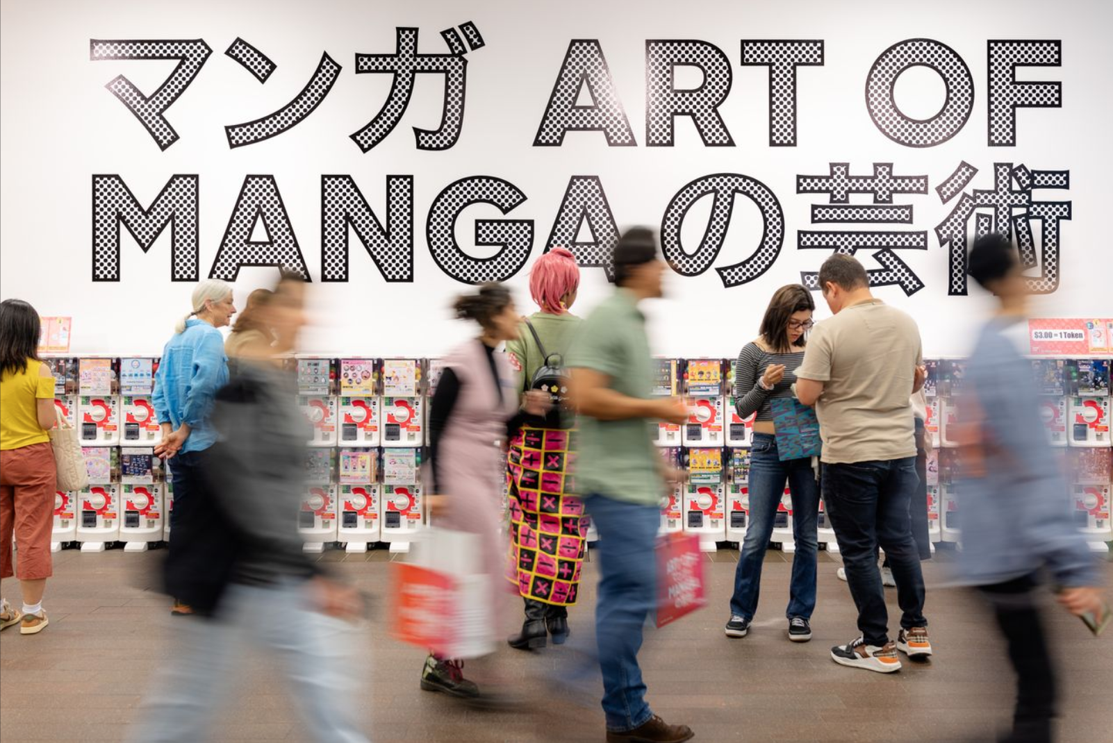 motion blue of the crowd walking past the toy machines