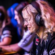 three female gamers sitting in there gaming set up side by side