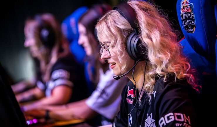 three female gamers sitting in there gaming set up side by side