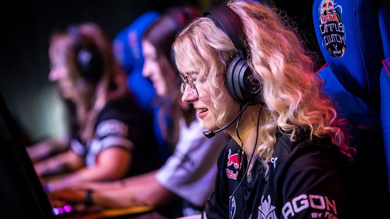 three female gamers sitting in there gaming set up side by side