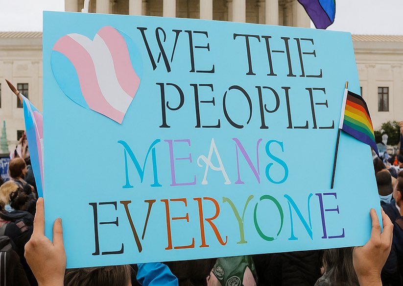 a protestors sign with a rainbow flag on a pole sticker and a pink, blue and white heart. the sign reads "we the people means everyone